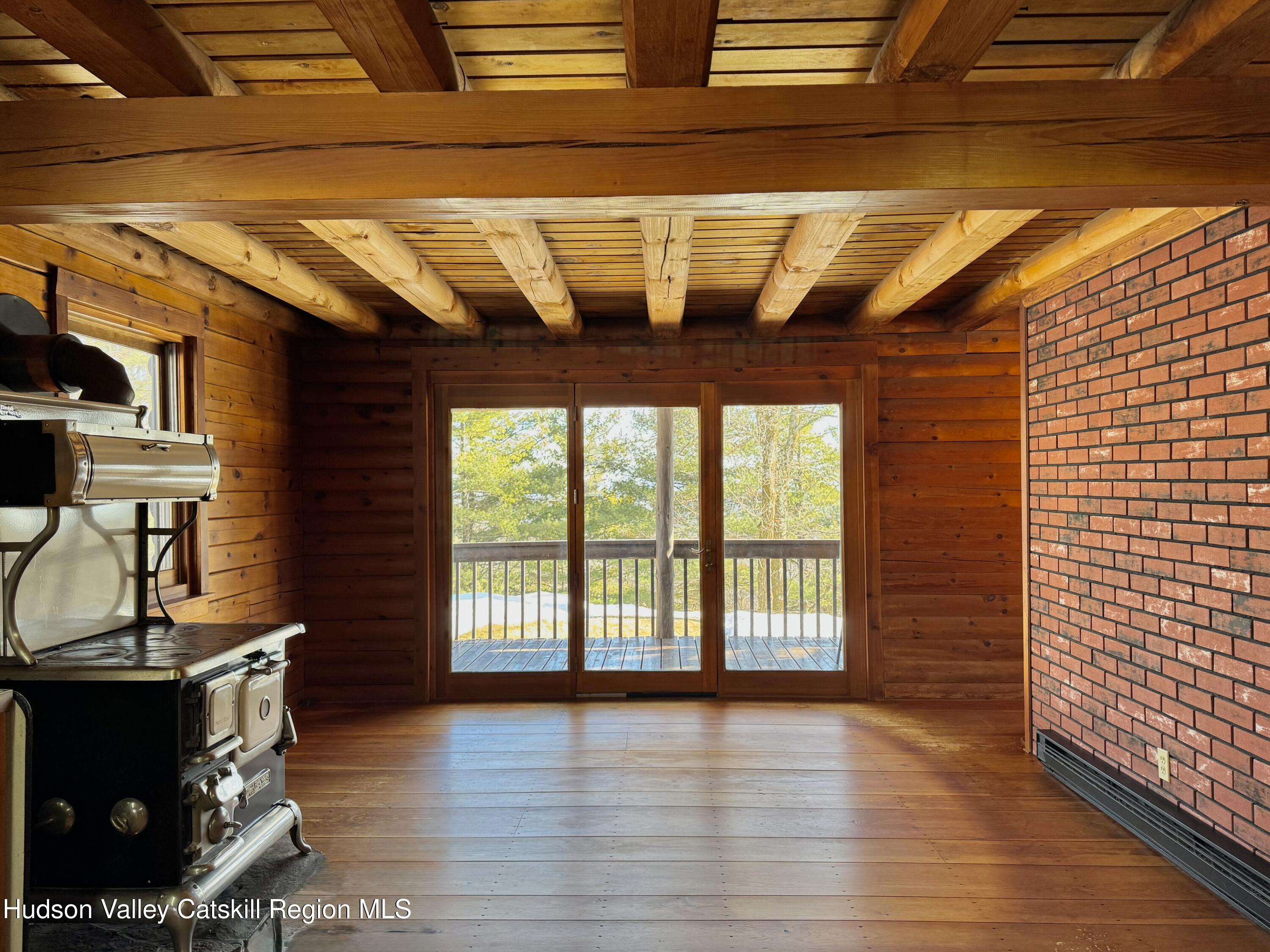 380 Easy Street Catskill, NY 12414 - Photo 23 of 57 a view of an empty room with wooden floor and a window