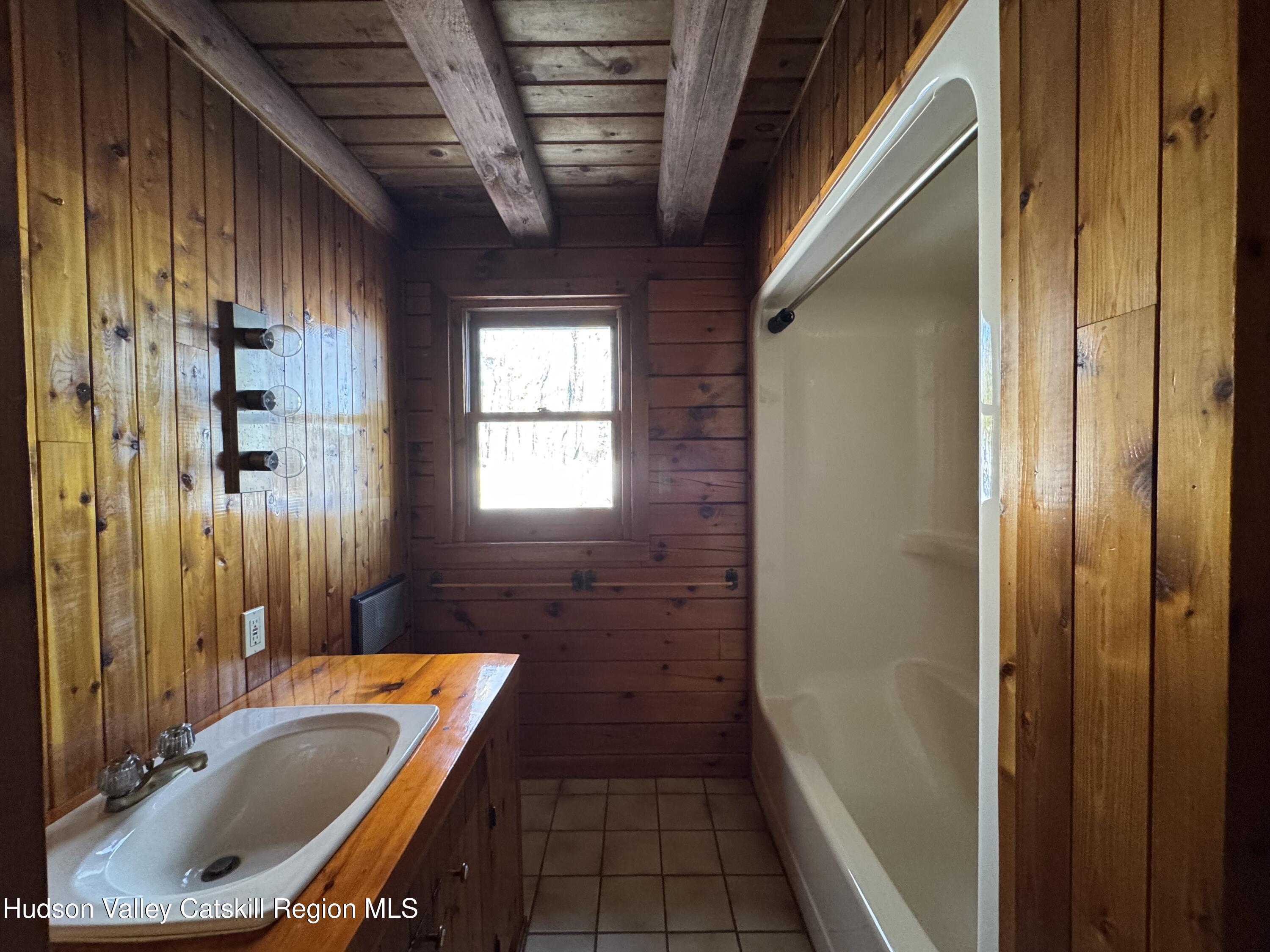 380 Easy Street Catskill, NY 12414 - Photo 35 of 57 a bathroom with a tub sink and shower