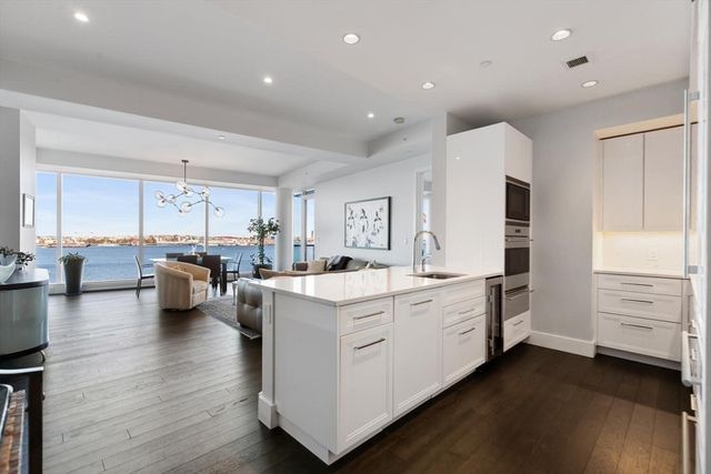 a large white kitchen with stainless steel appliances