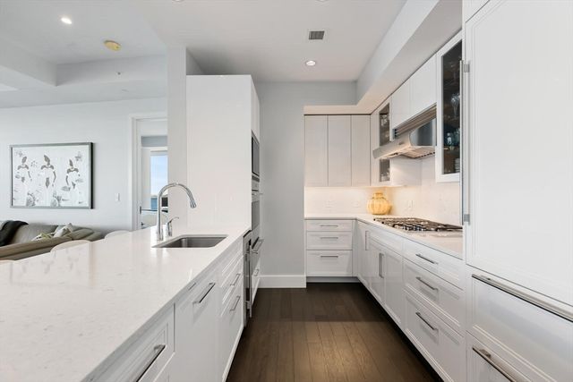 a kitchen with stainless steel appliances granite countertop a sink and cabinets