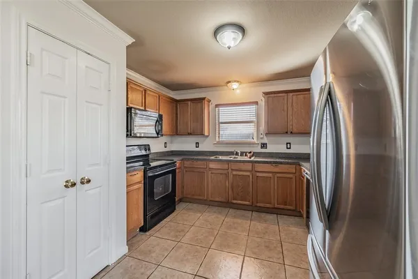 a kitchen with stainless steel appliances granite countertop a refrigerator sink and cabinets