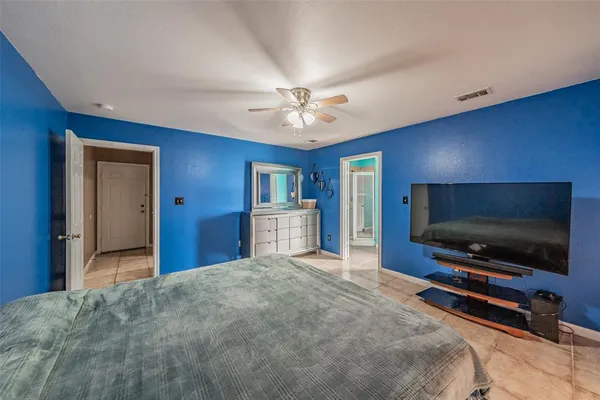 a bedroom with furniture and a flat screen tv