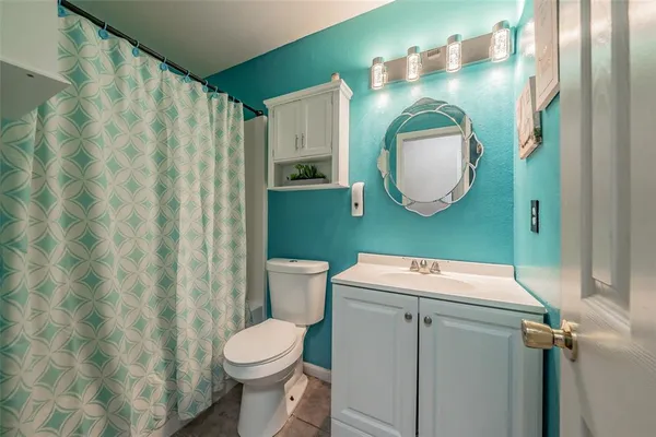 a bathroom with a sink toilet and mirror