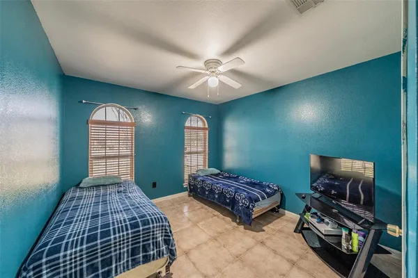a bedroom with bed and a window