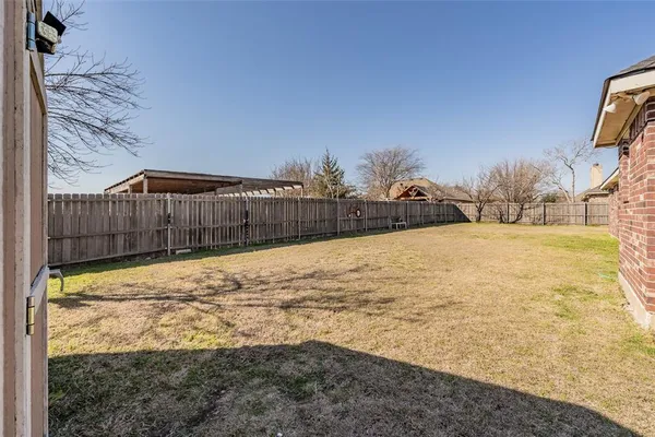 a view of small yard with a fence