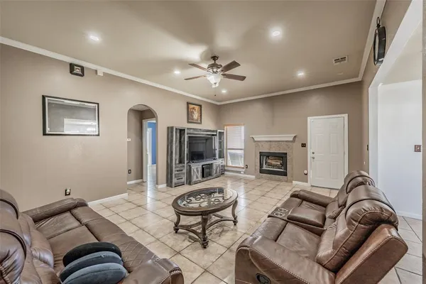 a living room with furniture a fireplace and a flat screen tv