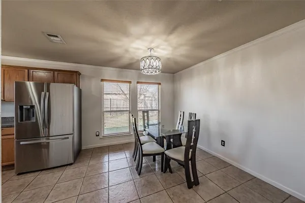 a view of a dining room with furniture and a window