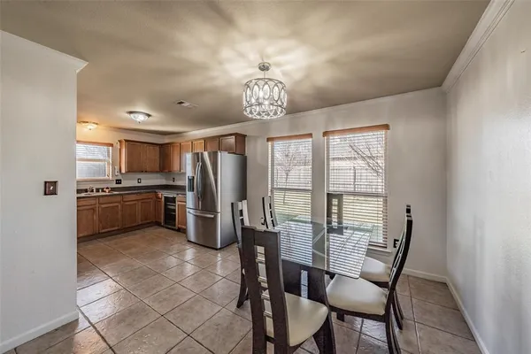 a view of a kitchen with refrigerator furniture and a ceiling fan