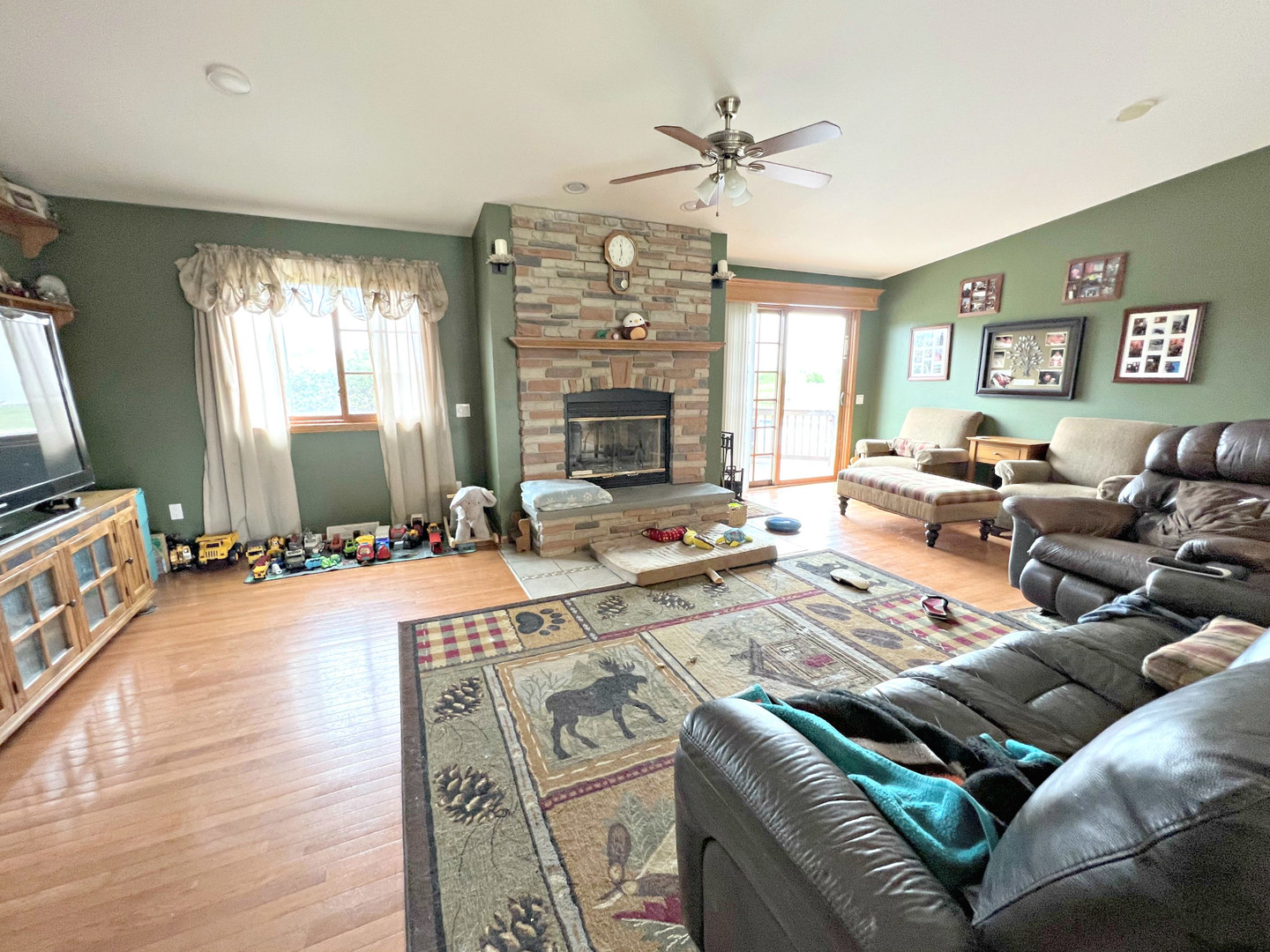 14508 Nichols Road Hebron, IL 60034 - Photo 12 of 38 a living room with furniture a fireplace and a flat screen tv
