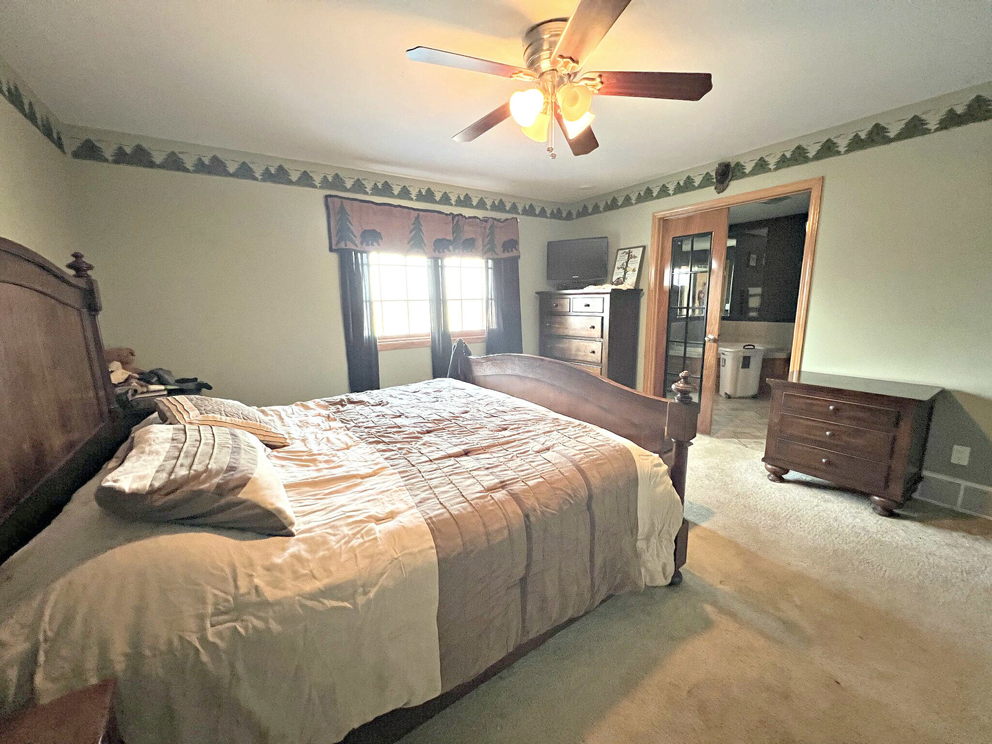 14508 Nichols Road Hebron, IL 60034 - Photo 14 of 38 a bedroom with a large bed and a chandelier