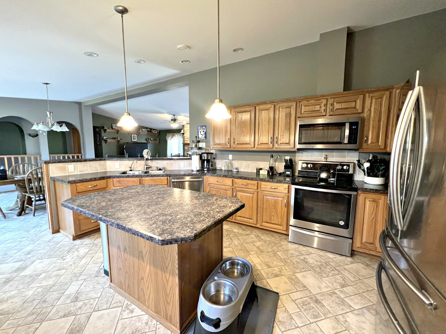 14508 Nichols Road Hebron, IL 60034 - Photo 9 of 38 a kitchen with stainless steel appliances granite countertop a sink a stove and a wooden floors