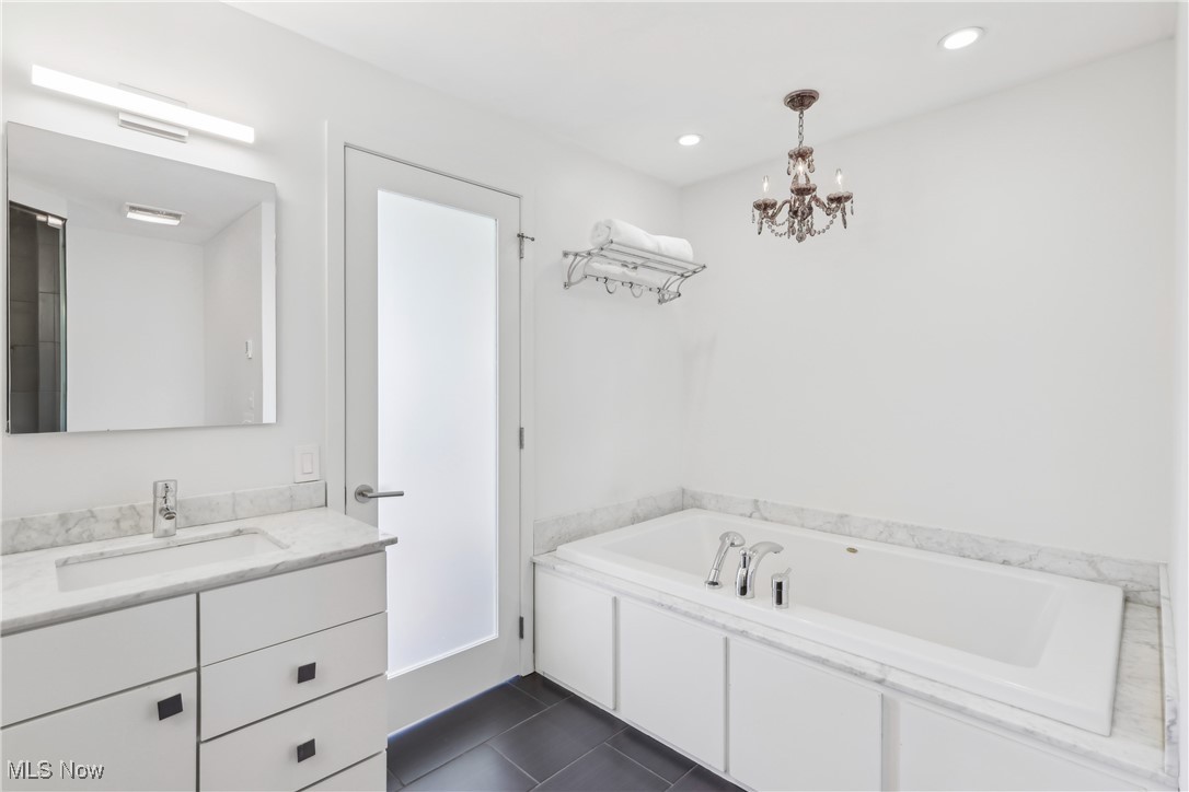 1852 Coltman Road Cleveland, OH 44106 - Photo 24 of 39 Primary Bathroom with recessed lighting, tile patterned floors, vanity, and a notable chandelier
