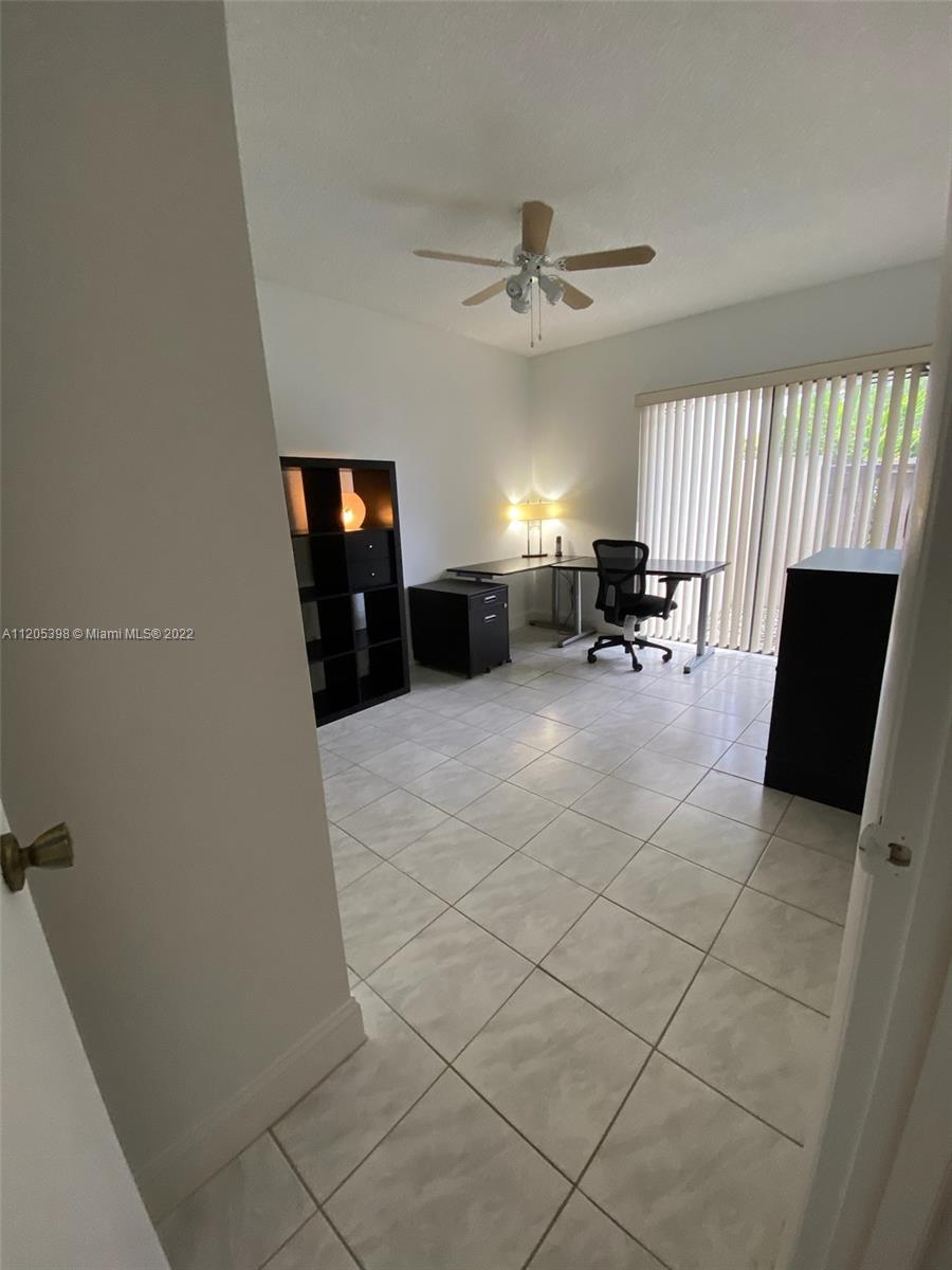 10478 Southwest 75th Lane Miami, FL 33173 - Photo 12 of 45 a view of a livingroom with furniture and a ceiling fan