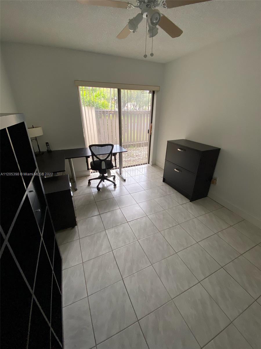 10478 Southwest 75th Lane Miami, FL 33173 - Photo 18 of 45 a living room with furniture and a floor to ceiling window