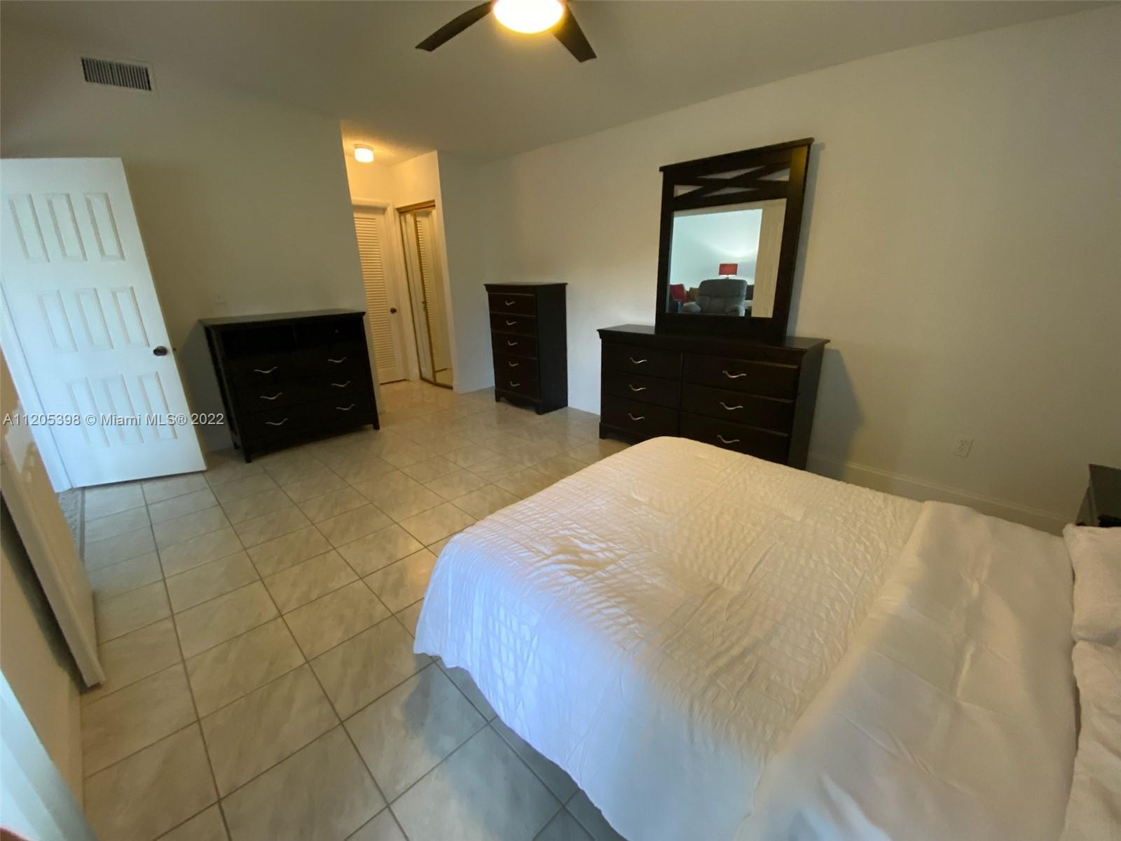 10478 Southwest 75th Lane Miami, FL 33173 - Photo 25 of 45 a bedroom with a bed and a dresser