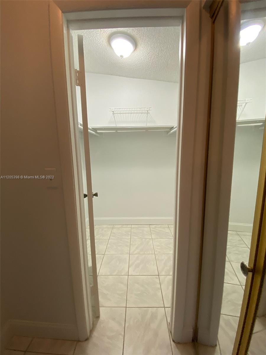 10478 Southwest 75th Lane Miami, FL 33173 - Photo 26 of 45 a bathroom with a glass door shower and a sink