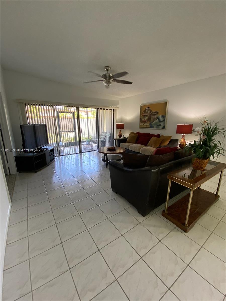 10478 Southwest 75th Lane Miami, FL 33173 - Photo 30 of 45 a living room with furniture and a flat screen tv