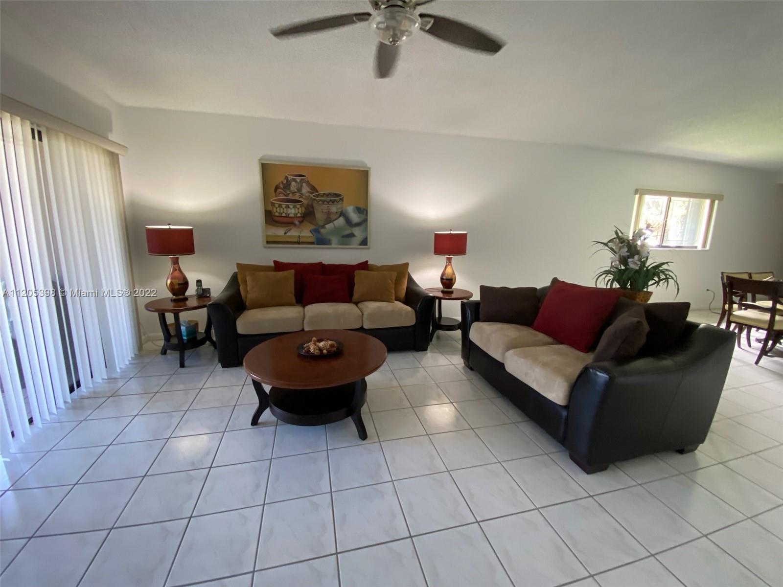 10478 Southwest 75th Lane Miami, FL 33173 - Photo 32 of 45 a living room with furniture and a ceiling fan