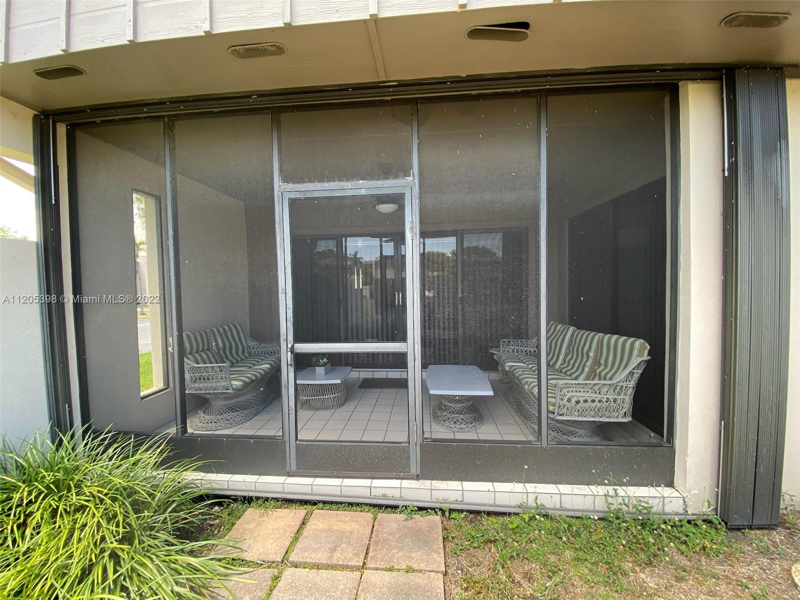10478 Southwest 75th Lane Miami, FL 33173 - Photo 42 of 45 a glass door with a bench in front of it