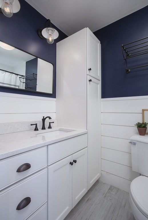 96 Dix Street, Unit 2 Boston, MA 02122 - Photo 5 of 11 a bathroom with a toilet a sink a vanity and mirror