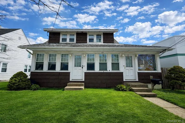 front view of a house with a yard