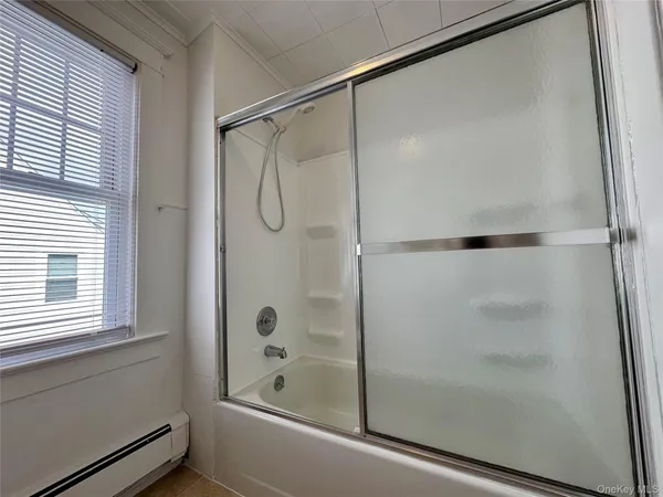 a bathroom with a shower and a bath tub