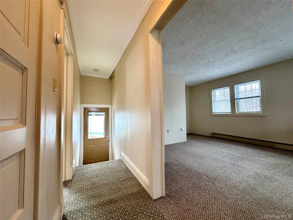 an empty room with windows and closet