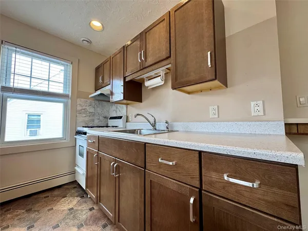 a kitchen with stainless steel appliances granite countertop a sink a stove and a microwave