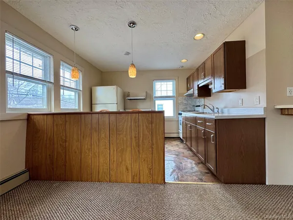 a kitchen with stainless steel appliances granite countertop a sink a stove and a refrigerator