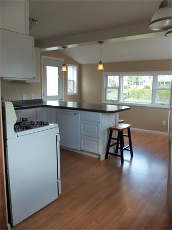 10 Canterbury Road Springfield, MA 01118 - Photo 6 of 15 a kitchen with a table chairs a sink and a stove