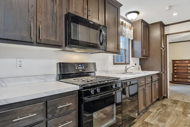 a kitchen with stainless steel appliances granite countertop a stove and a microwave