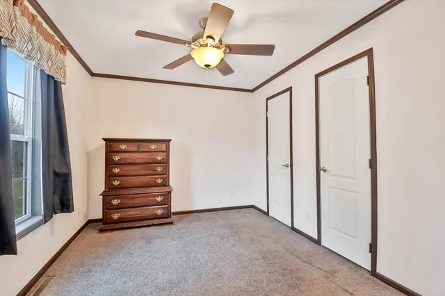 a view of room with stairs and a ceiling fan