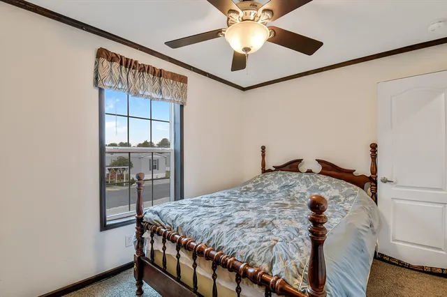 a bed sitting in a bedroom next to a window