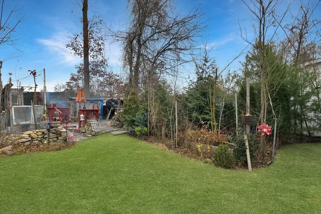 a view of a chairs and tables in the back yard