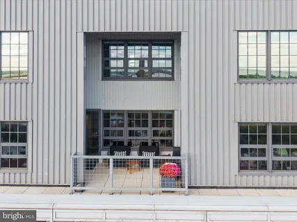a view of a workspace with furniture and a book shelf
