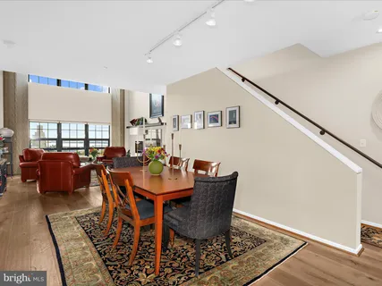 a bedroom with a bed large window and a walk in closet