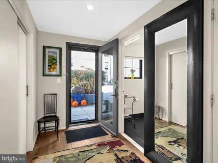 a kitchen with a sink cabinets and wooden floor