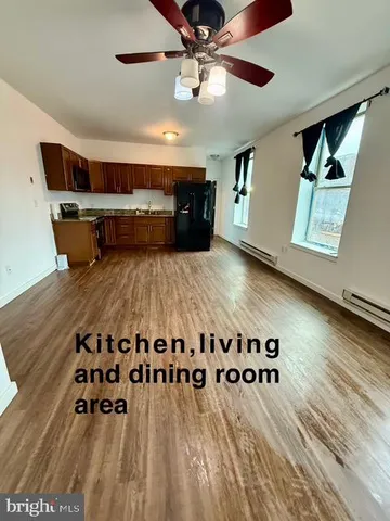 a living room with lots of furniture and wooden floor