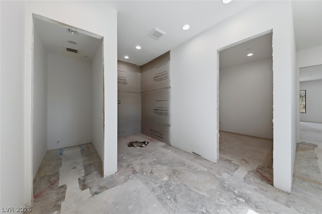 1140 Julie Road Henderson, NV 89002 - Photo 50 of 71 Recessed lighting illuminates this room, awaiting its finishing touches for a modern living space.