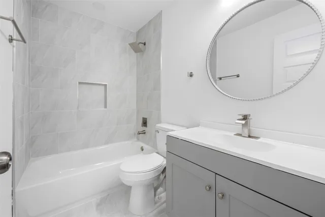 a bathroom with a sink a toilet and a mirror