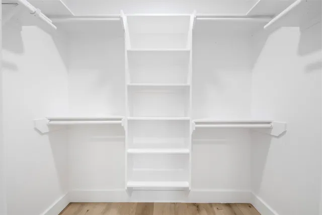 a view of a backyard with a large tree and wooden fence