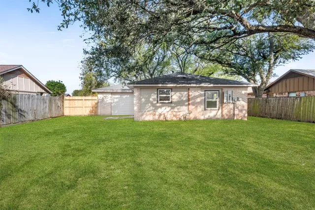 a view of house with backyard