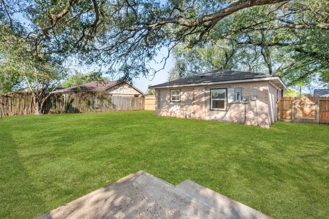 a view of back yard of the house with an outdoor space