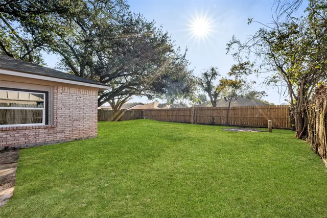 a view of a house with a yard and sitting area