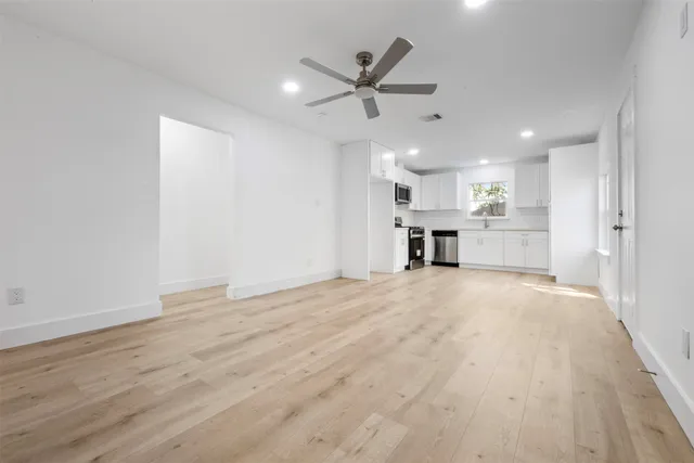 a view of a kitchen with a sink and a stove top oven