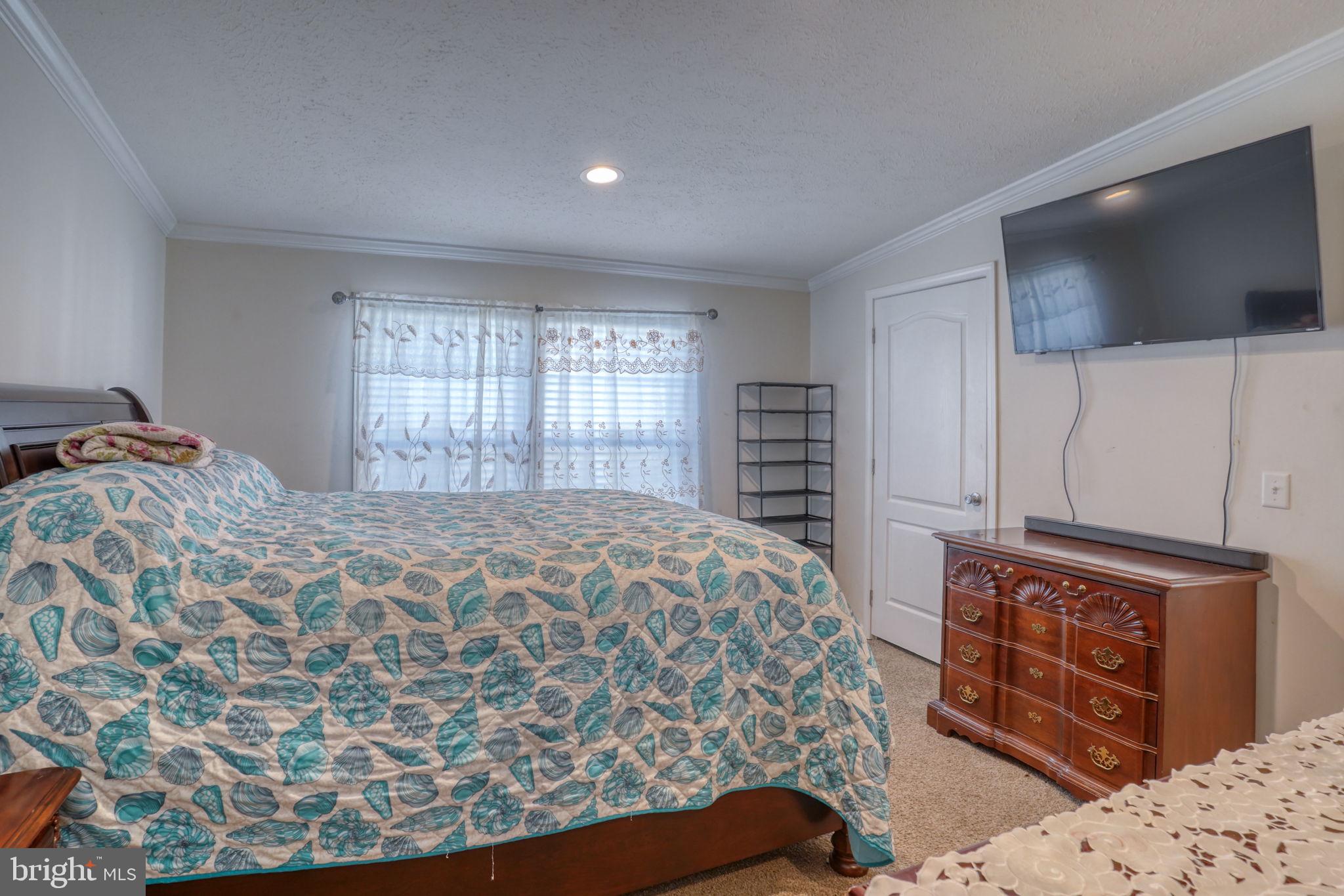 413 4th Street Frederica, DE 19946 - Photo 17 of 31 a bedroom with a bed and a flat screen tv