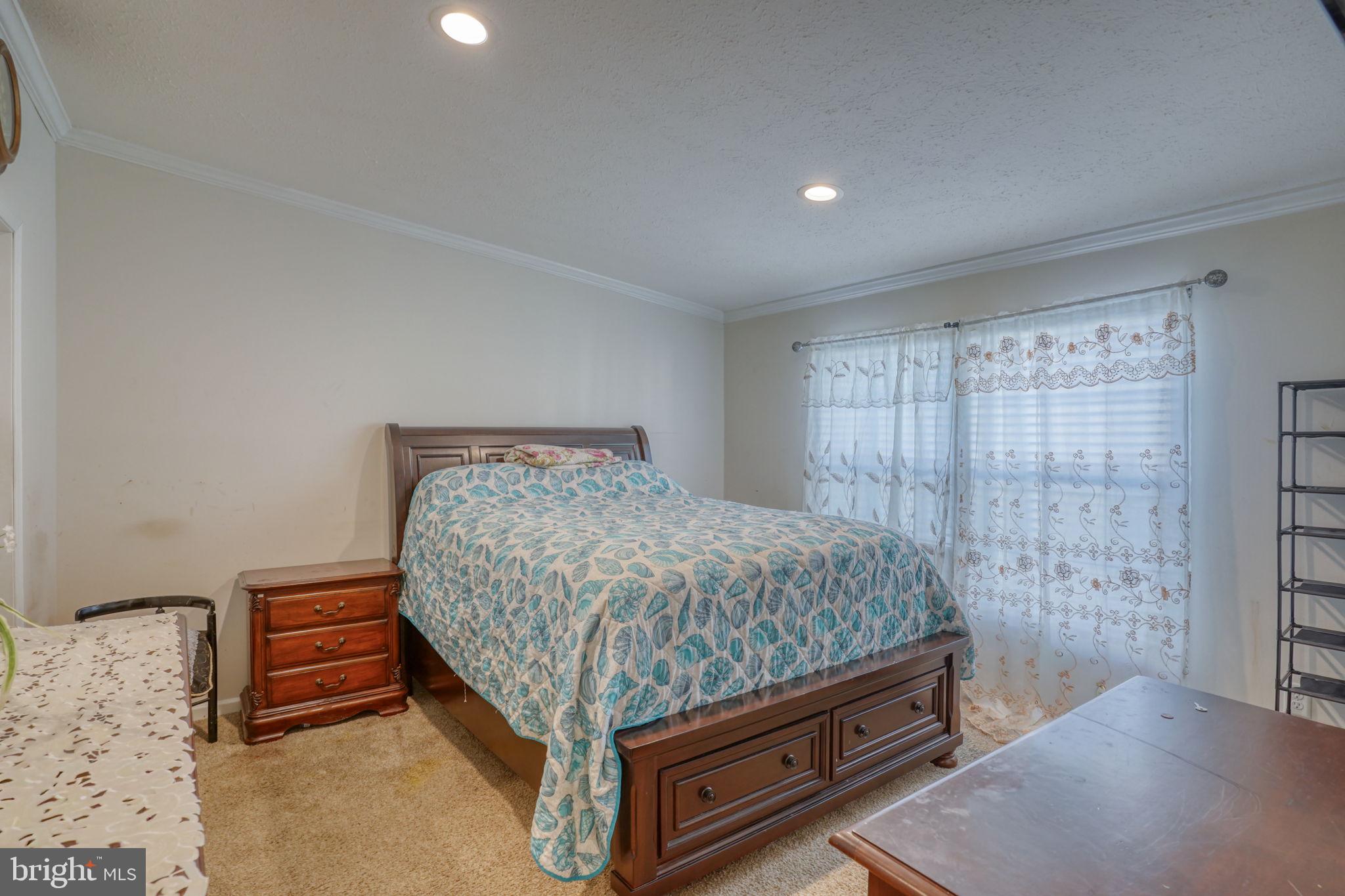 413 4th Street Frederica, DE 19946 - Photo 18 of 31 a bed sitting in a room next to a window