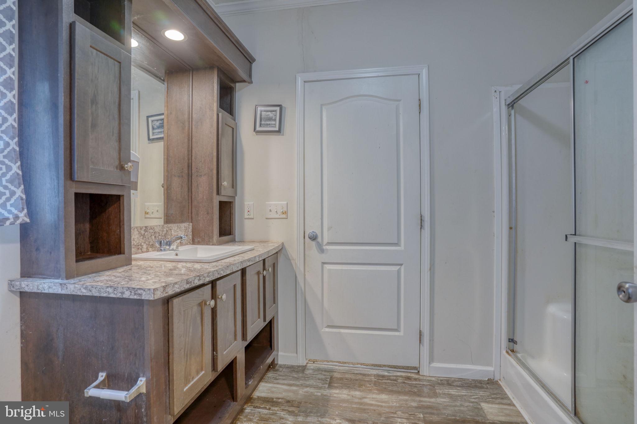 413 4th Street Frederica, DE 19946 - Photo 19 of 31 a bathroom with a granite countertop sink and a mirror