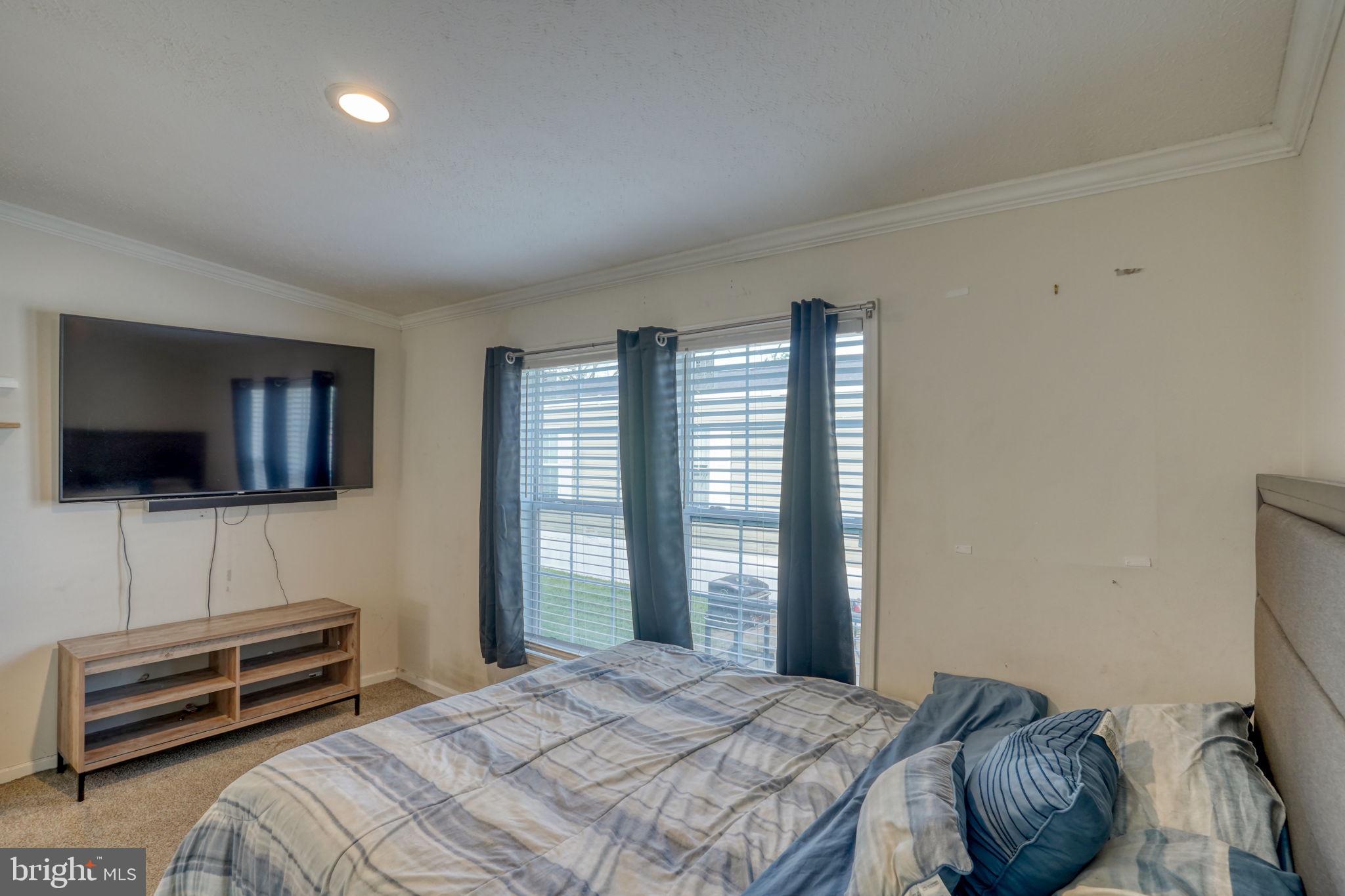 413 4th Street Frederica, DE 19946 - Photo 20 of 31 a bedroom with a bed and a flat screen tv