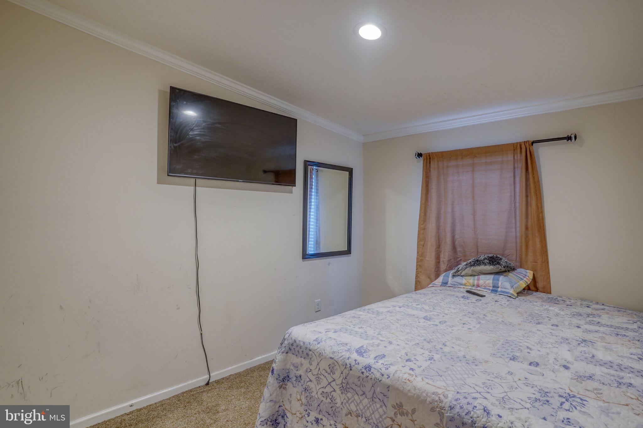 413 4th Street Frederica, DE 19946 - Photo 23 of 31 a bedroom with a bed and a flat screen tv